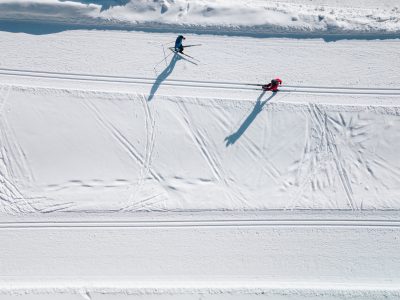 Aerial view of ski tracks in snow. Men skiing in Finland.